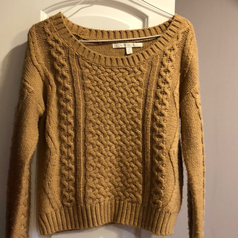 A thick tan colored sweater